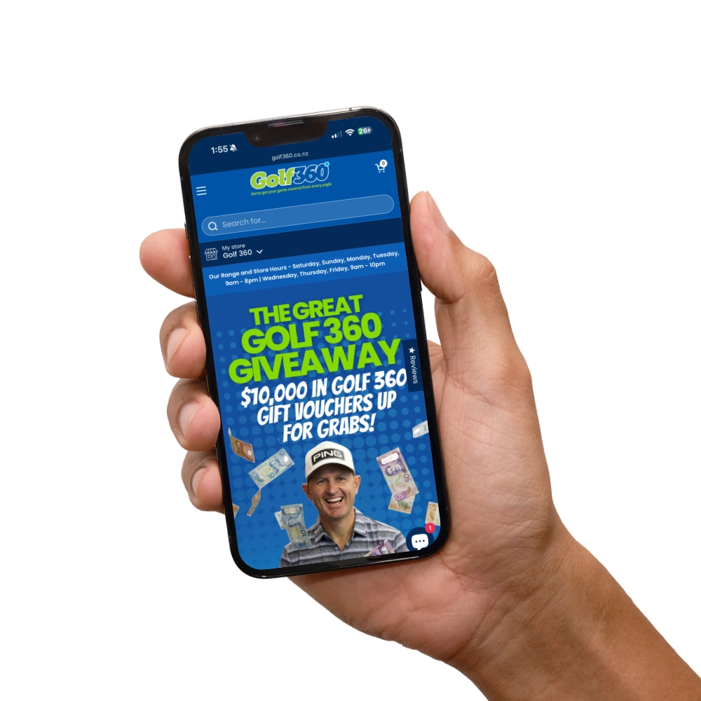 Hand holding mobile phone with website.